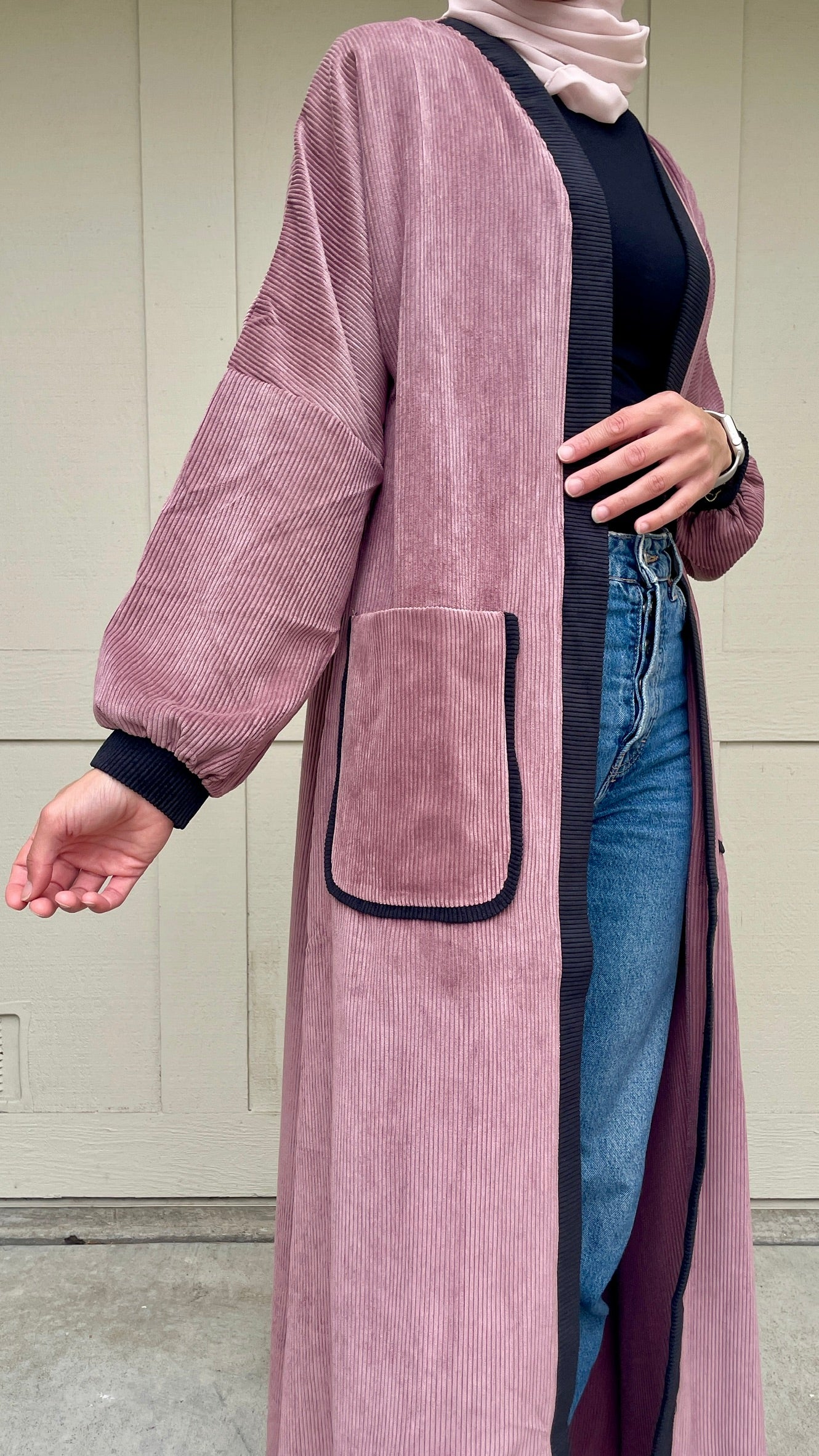 closer look of the purple cardigan made of corduroy with pockets, perfect for layering in winter