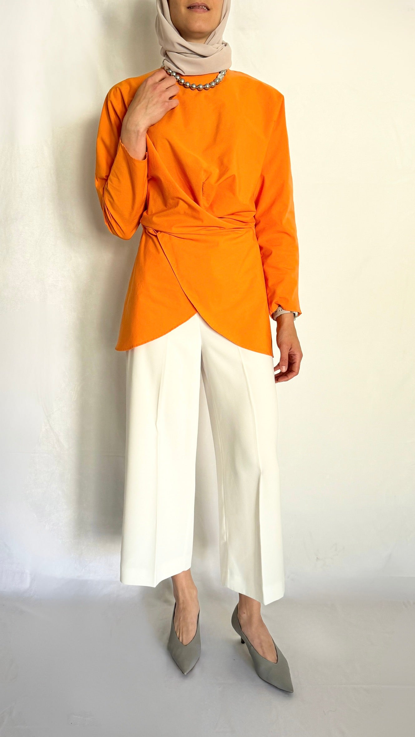 Tied wrap tunic in apricot color.