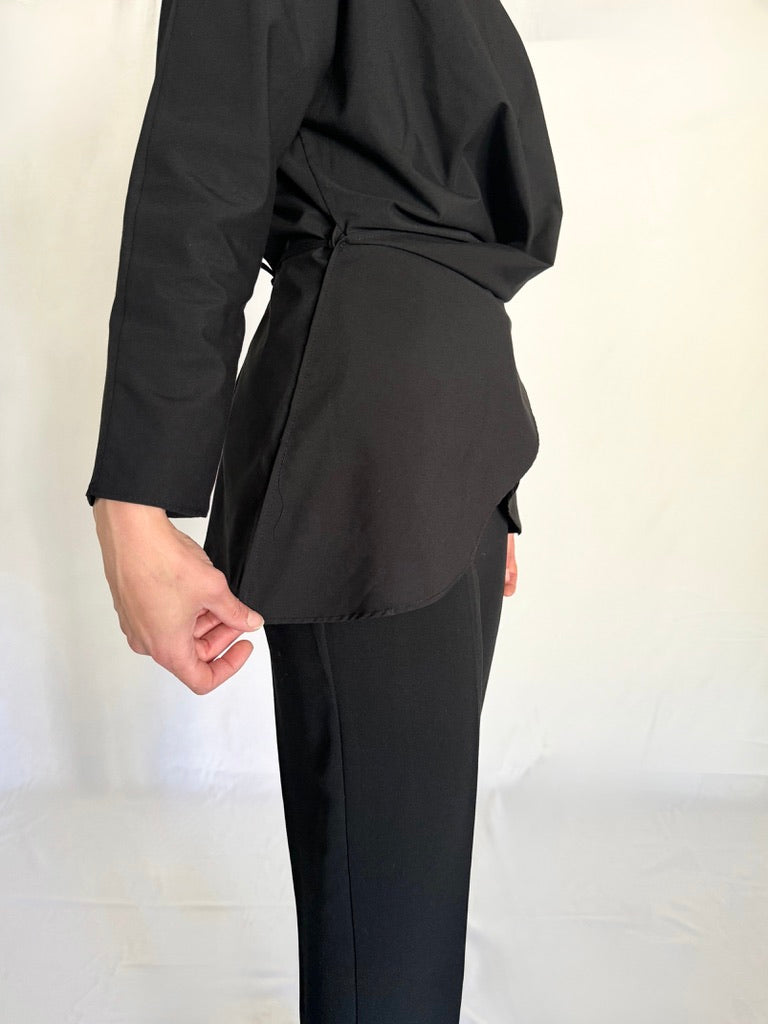 Side view of the black shirt that is made of Polyester and cotton