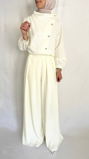 Ivory long sleeve shirt with gold buttons.